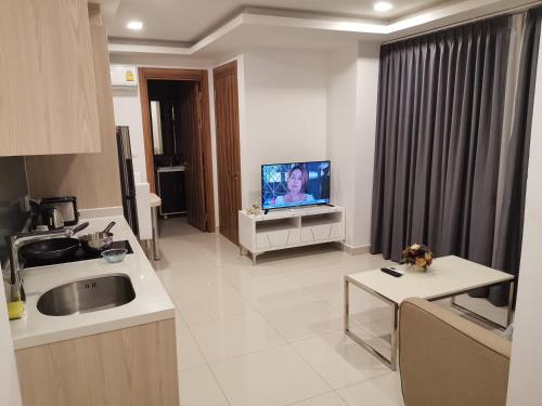 a kitchen with a sink and a tv in a room at 2BDR in Water Resort close to WalkingStreet in Pattaya South