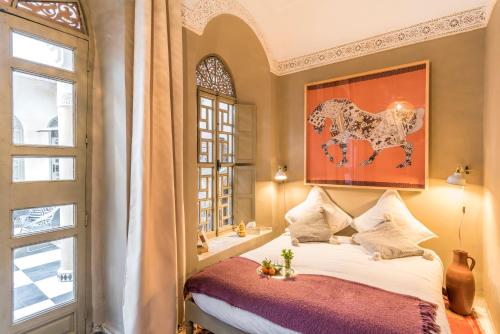 Säng eller sängar i ett rum på Riad Hissan