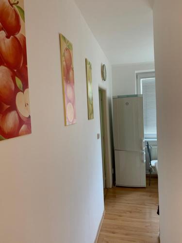 a room with a refrigerator and two pictures on the wall at Apartment Botanika2 in Trnava