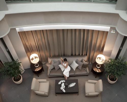 a living room filled with furniture and a large window at SPA Complex Luciano in Kazan