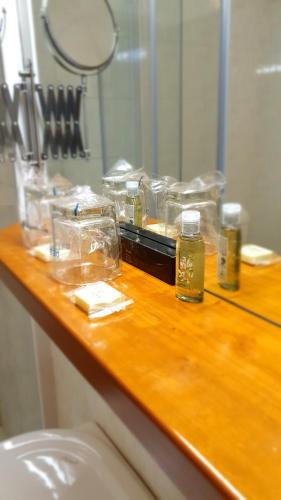 a bathroom counter with a mirror and some items on it at Hotel Sporn in Radomlje
