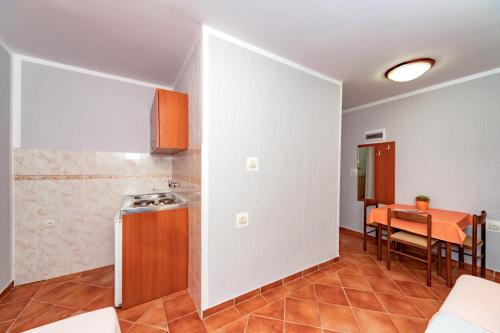 a kitchen and a dining room with a table at Villa Glavanovic in Bar