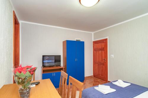 a dining room with a table and a blue cabinet at Villa Glavanovic in Bar