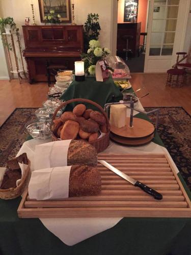 a table with a tray of bread on a table at Medio Apartments in Fredericia