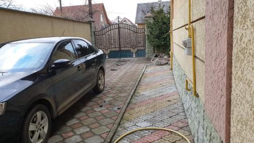 a car parked on a street next to a building at Viktoria in Uzhhorod