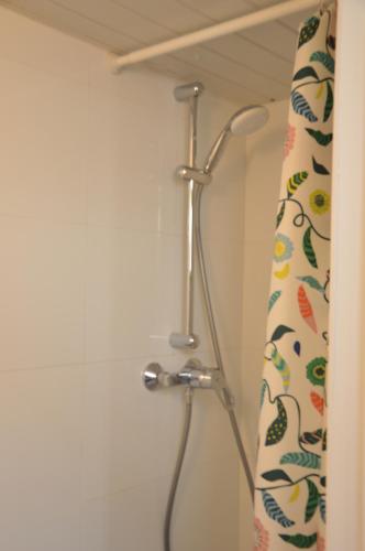 a shower curtain in a bathroom with a shower head at Awesome Studio in Marolles in Brussels