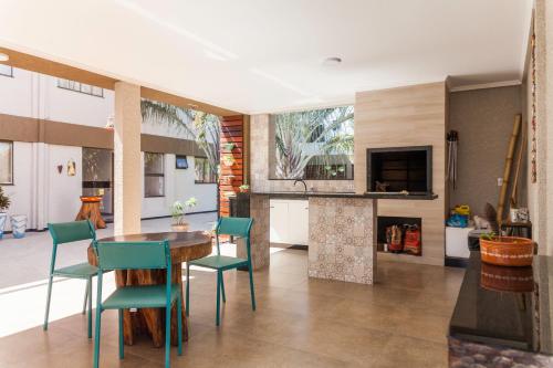 a kitchen with a table and chairs in a room at Hotel Holiday Foz in Foz do Iguaçu