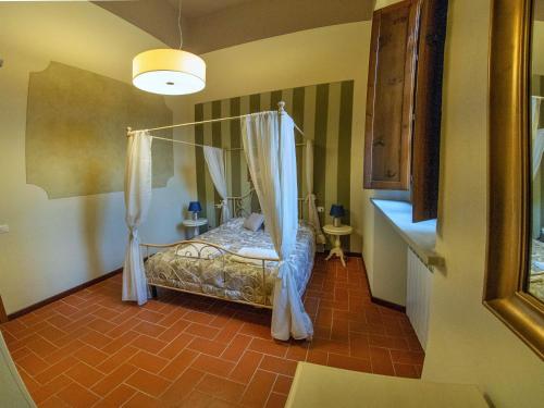 a bedroom with a bed with a canopy at Residence La Poggerina in Figline Valdarno