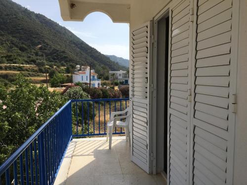 a white chair sitting on a balcony with a view at A.A Michael Apartments in Pachyammos