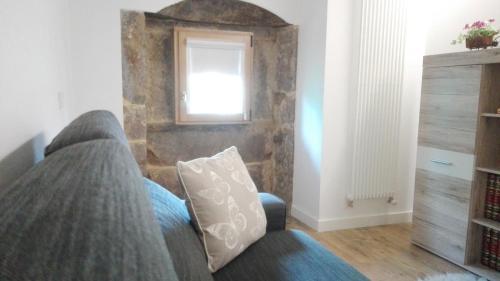 a living room with a couch and a window at Apartamentos Turísticos Los Picos in Liérganes