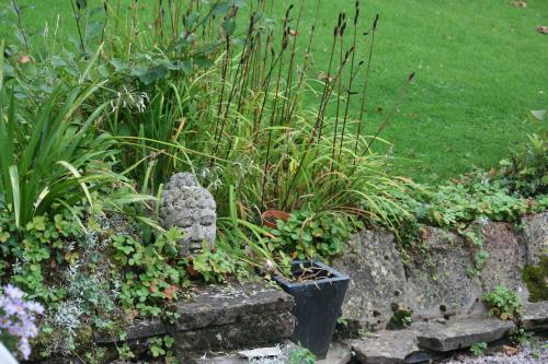 a garden with a statue and some plants at Torlands in Monmouth