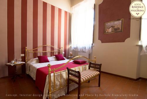 a bedroom with a bed and two chairs and a window at Residence La Poggerina in Figline Valdarno