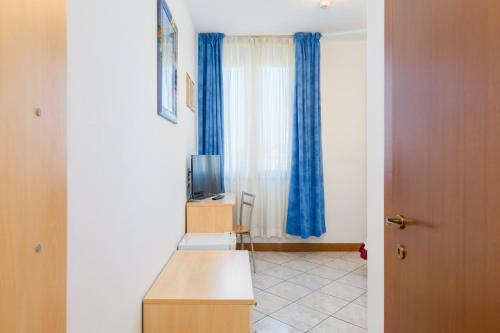 a room with a desk and a television and a door at B&B New Aurora Venice in Marghera