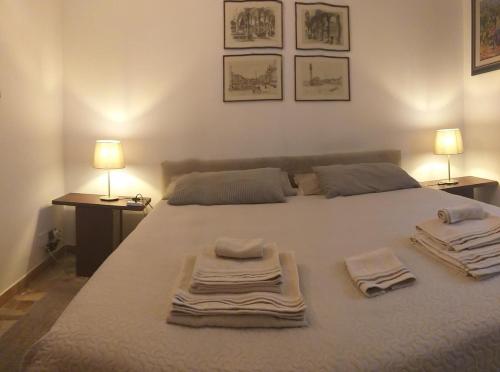 a bedroom with a large bed with towels on it at B&B Jacopino in Florence