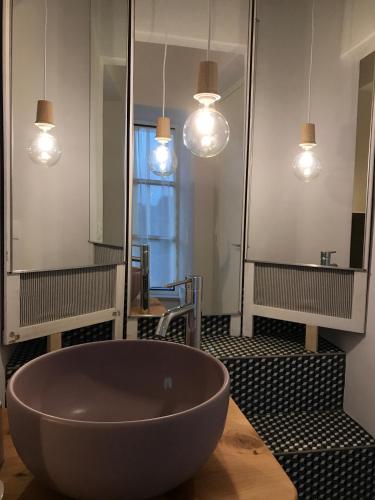 a bathroom with a large bowl sink and mirrors at Corte Viviani in Brescia