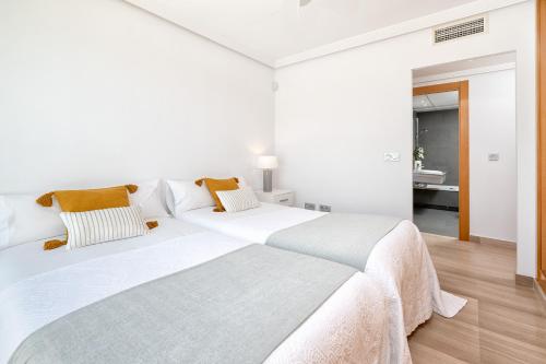 a white bedroom with a large white bed at iloftmalaga Ático Pacífico 19 B in Málaga