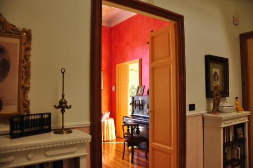 a room with a door open to a room with a piano at La casa dei Paggi in Sestri Levante