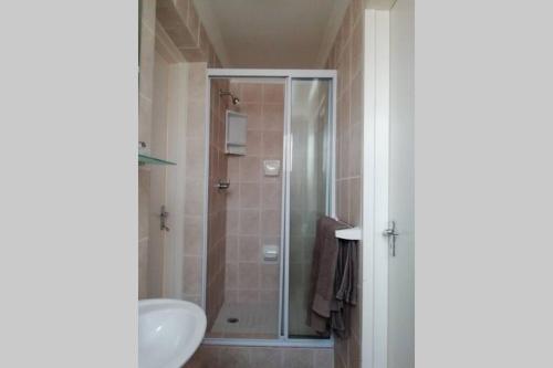 a bathroom with a shower and a sink at Clarens Socialites Garden Apartment #2 in Bethlehem