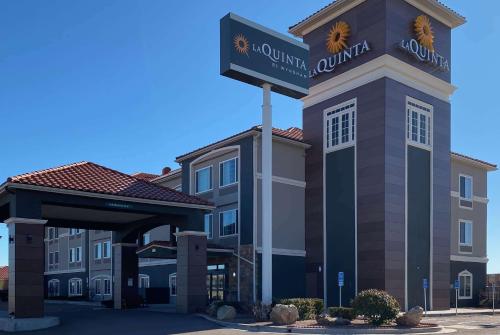a hotel with a sign in front of a building at La Quinta by Wyndham Gallup in Gallup
