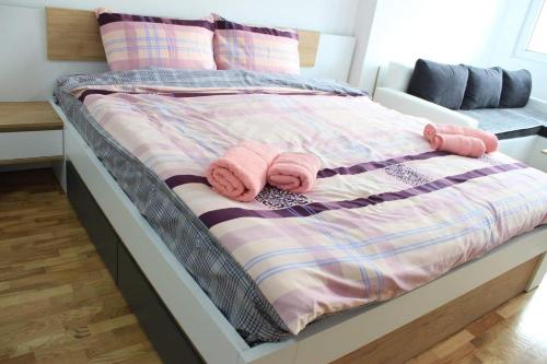 a bed with pink towels on top of it at Apartments S*A in Ohrid