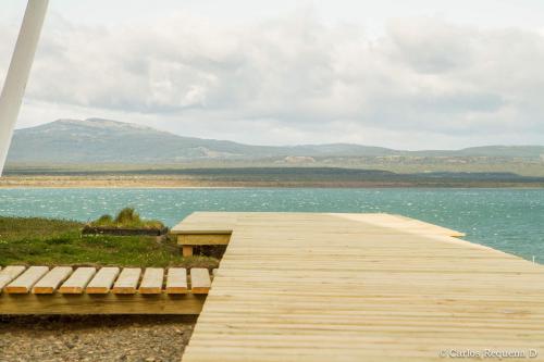 a wooden bridge over a body of water at Best Western Patagonia in Puerto Natales