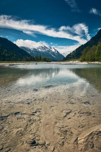a view of a river with mountains in the background at Der Tannenhof in Reutte