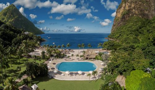 an aerial view of a resort with a pool and the ocean at Sugar Beach, A Viceroy Resort in Soufri&egrave;re