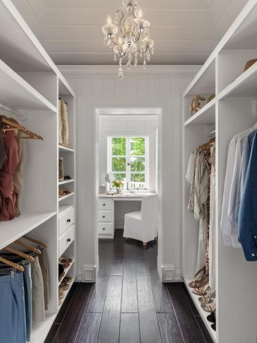 a walk in closet with a chandelier and a desk at Sugar Beach, A Viceroy Resort in Soufrière