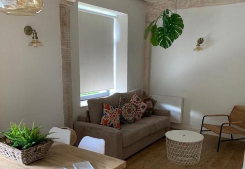 a living room with a couch and a table at Apartamentos La Bicicleta in Puente Viesgo