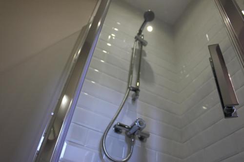 a bathroom with a shower with a shower head at Prince of Wales in East Cowes