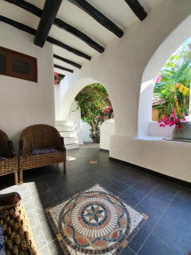 a room with two chairs and a rug on the floor at Stromboli Vacanze in Stromboli