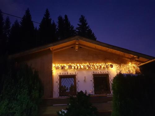 a house decorated with christmas lights at night at Knusperhäuschen Maria Nikoletta in Witra