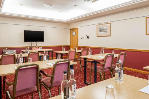 a conference room with tables and chairs and a flat screen tv at Comfort Inn Arundel in Arundel