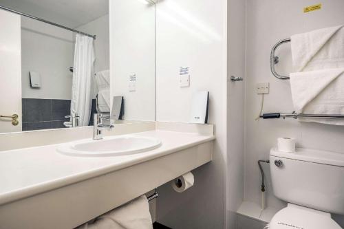 a white bathroom with a sink and a toilet at Comfort Inn Arundel in Arundel