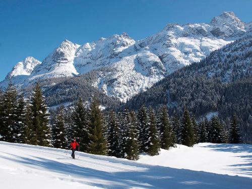 a person is skiing down a snow covered mountain at Berghof am Schwand in Hinterhornbach