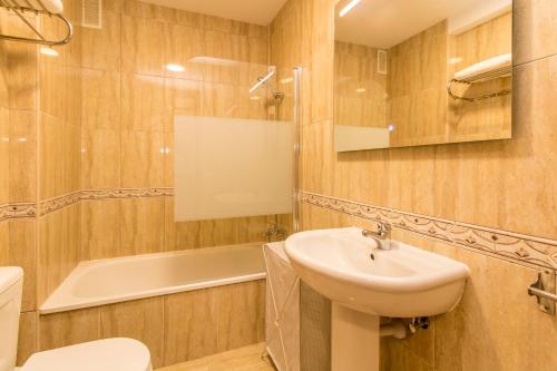 a bathroom with a sink and a toilet and a tub at Duplex Palm Mar B29 in Palm-mar