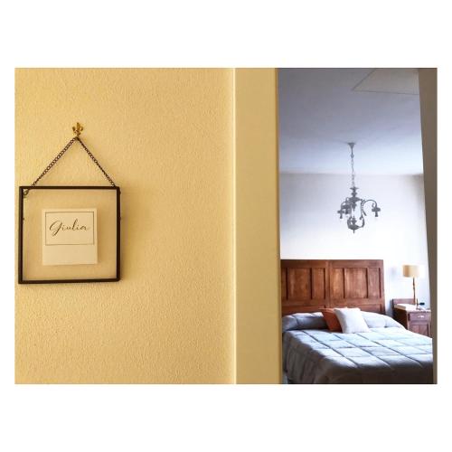 a picture of a bedroom with a bed and a mirror at Corte Viviani in Brescia