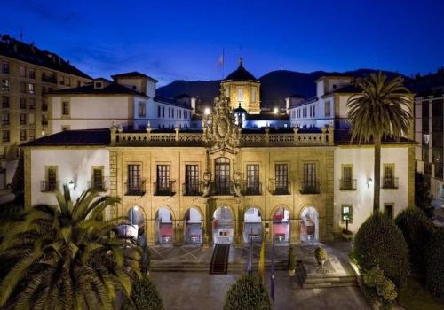 a large building with a clock tower on top of it at VUT 795 AS Apartamento Marqués de Teverga 10 in Oviedo