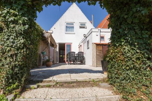 a view of a house through two hedges at Home sweet home in Breskens