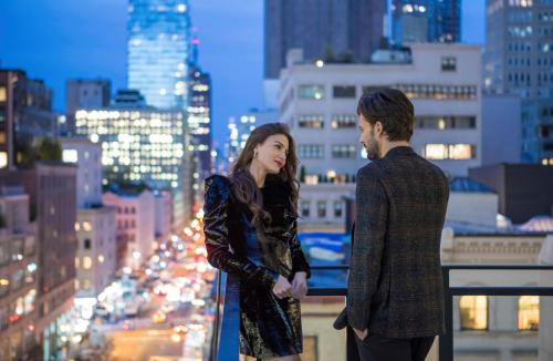 a man and a woman standing on top of a city at Four Seasons Hotel New York Downtown in New York