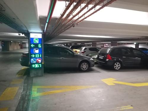 a parking lot with cars parked in a parking garage at Domum Universitate Dalles - Intercontinental in Bucharest