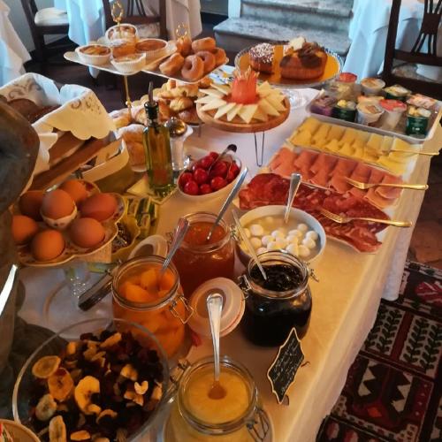 a table with many different types of food on it at Hotel Santa Caterina in Siena