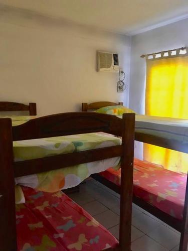 a bedroom with two bunk beds and a window at Le Parc in Gualeguaychú