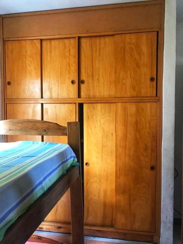 a wooden cabinet with a bed next to it at Le Parc in Gualeguaychú