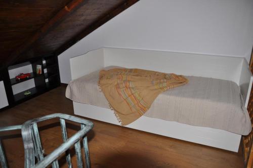 a bedroom with a bed and a chair in a attic at Quinta do Olival in Vilas Boas