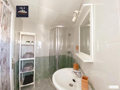 a bathroom with a sink and a shower and a mirror at Old Town Puerto del Carmen in Puerto del Carmen