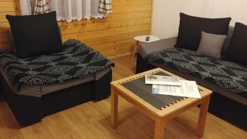 a living room with a couch and a coffee table at Sielanówek - Orzechowa Chatka z sauną wanną termalną jacuzzi in Żywiec