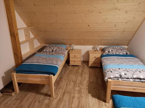 A bed or beds in a room at Drevenica Ľudmila pod Haťami