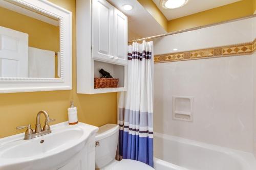 a bathroom with a sink and a toilet and a mirror at Breakers At Hilton Head in Hilton Head Island