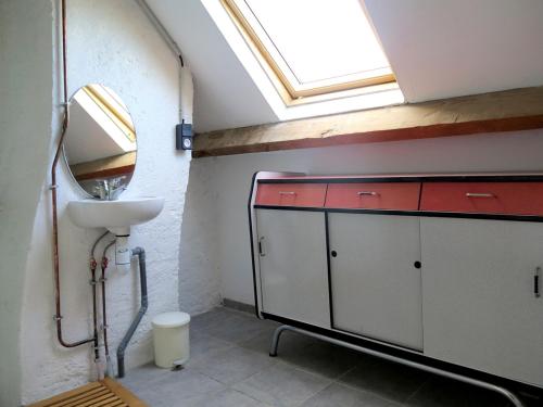 uma casa de banho com um lavatório e uma clarabóia em Les Abeilles em Saint-Nazaire